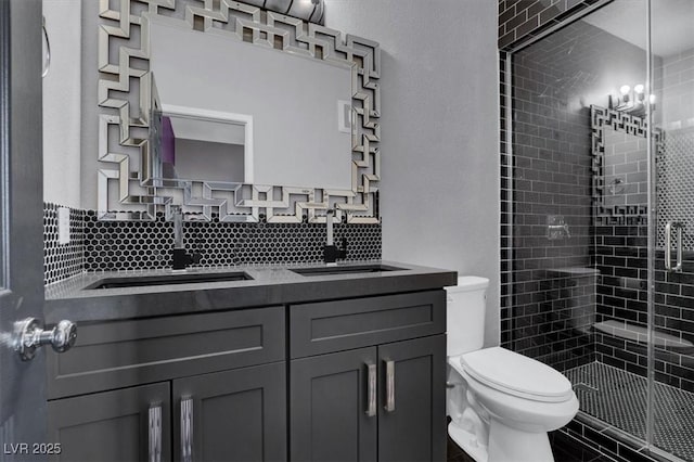 bathroom with tasteful backsplash, vanity, toilet, and walk in shower