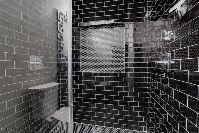 bathroom with tiled shower