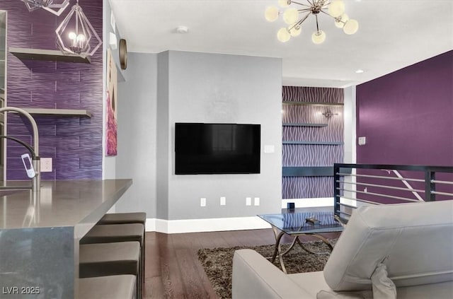 living room with wood-type flooring and a notable chandelier