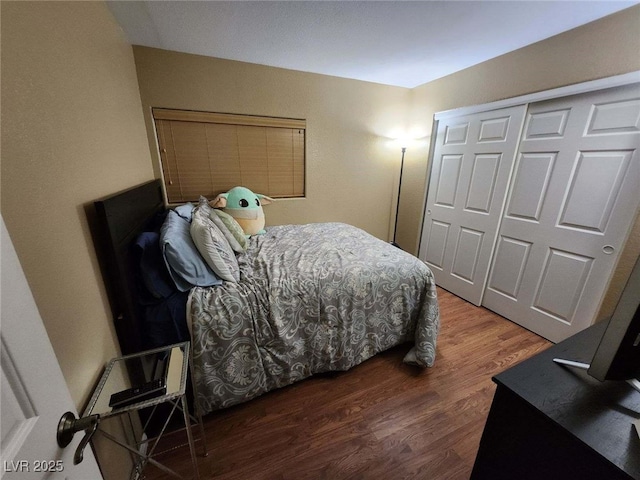 bedroom with a closet and dark hardwood / wood-style flooring