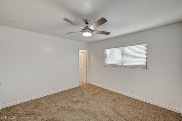 spare room featuring ceiling fan and light carpet