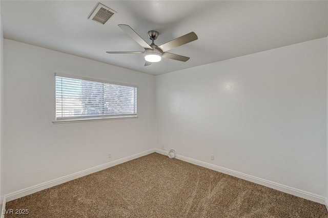 carpeted spare room featuring ceiling fan