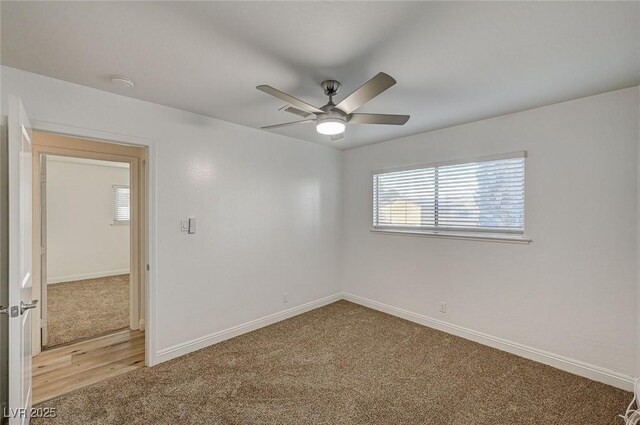 empty room with carpet floors and ceiling fan