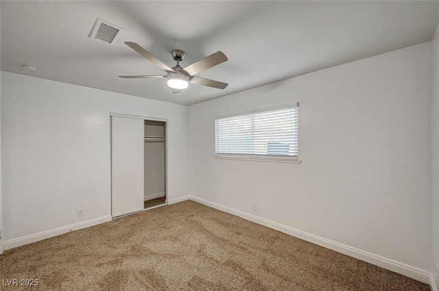 unfurnished bedroom featuring ceiling fan, a closet, and carpet