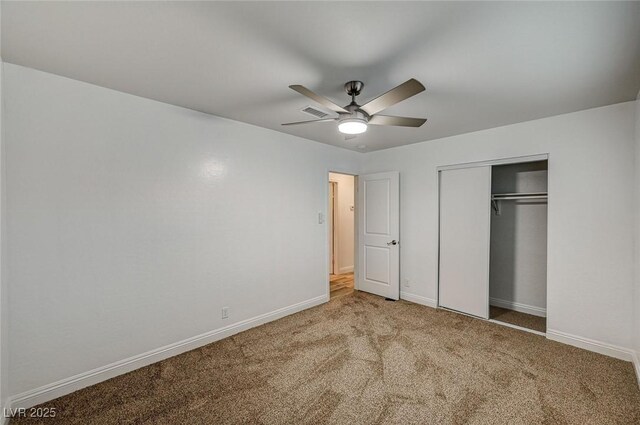 unfurnished bedroom with carpet, ceiling fan, and a closet