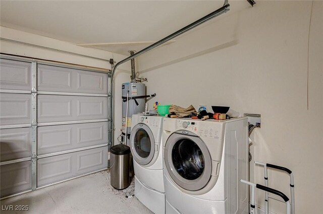 washroom with washing machine and clothes dryer and secured water heater