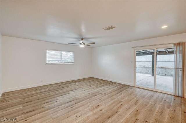 spare room with ceiling fan and light hardwood / wood-style floors