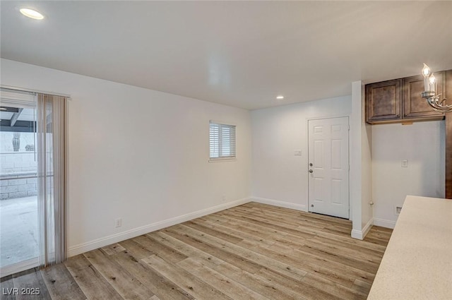 empty room with light hardwood / wood-style flooring