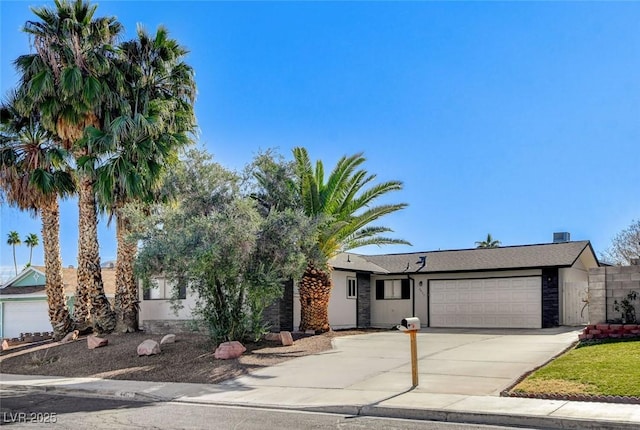 view of property hidden behind natural elements featuring a garage