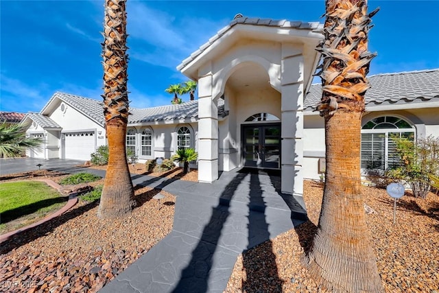 view of front of property featuring a garage and french doors