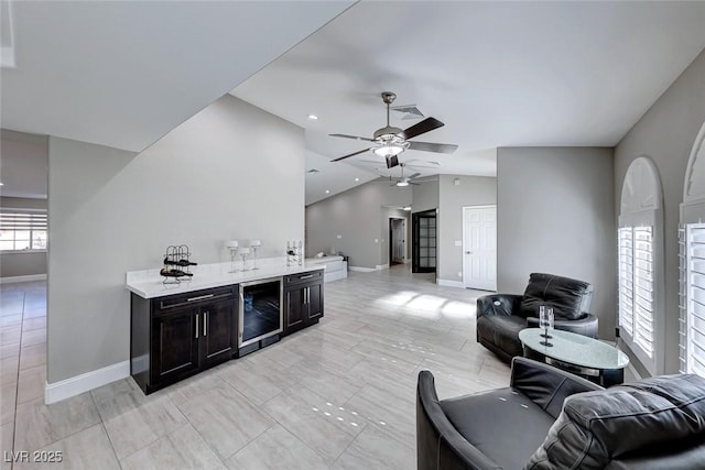 living room with ceiling fan, beverage cooler, and vaulted ceiling