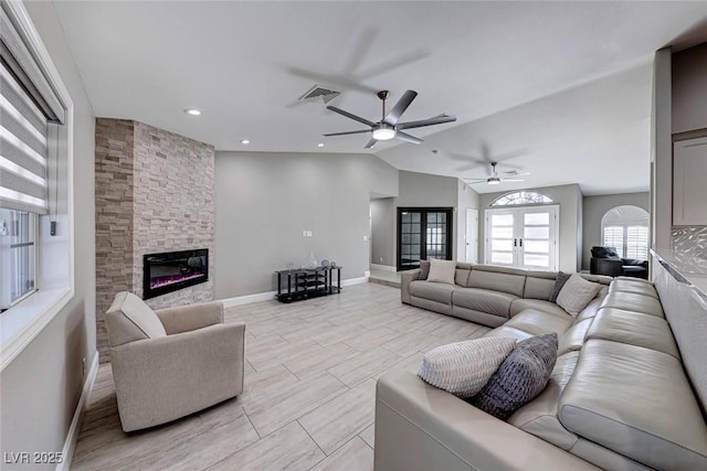 living room featuring a fireplace, ceiling fan, french doors, and lofted ceiling