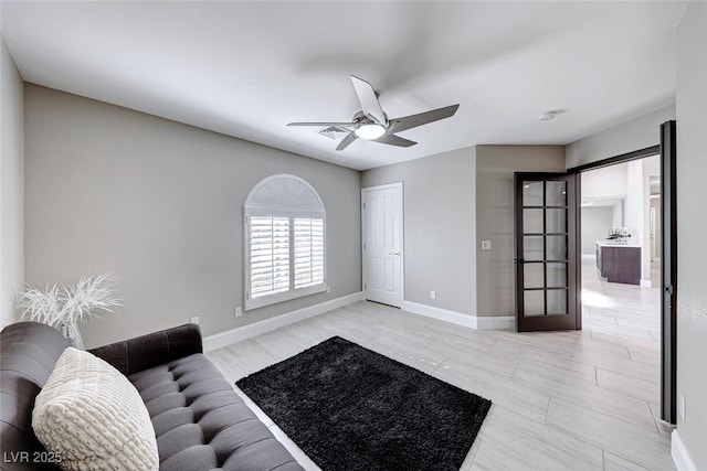 living room featuring french doors and ceiling fan