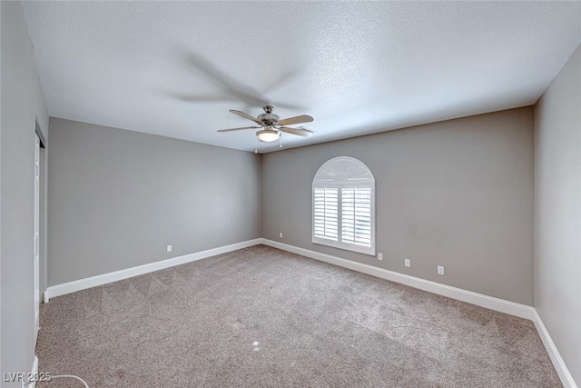 spare room with ceiling fan, carpet, and a textured ceiling