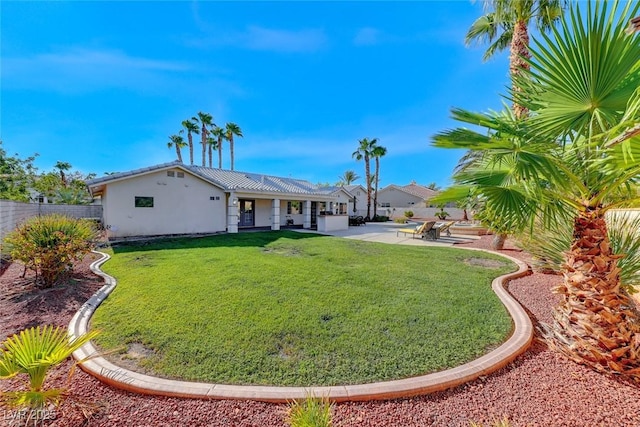 back of house featuring a yard and a patio