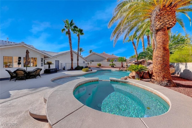 view of pool featuring an in ground hot tub and a patio