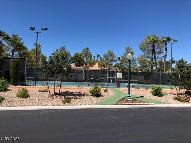 view of community featuring tennis court