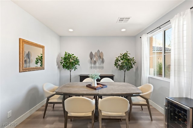 dining room with hardwood / wood-style floors and wine cooler