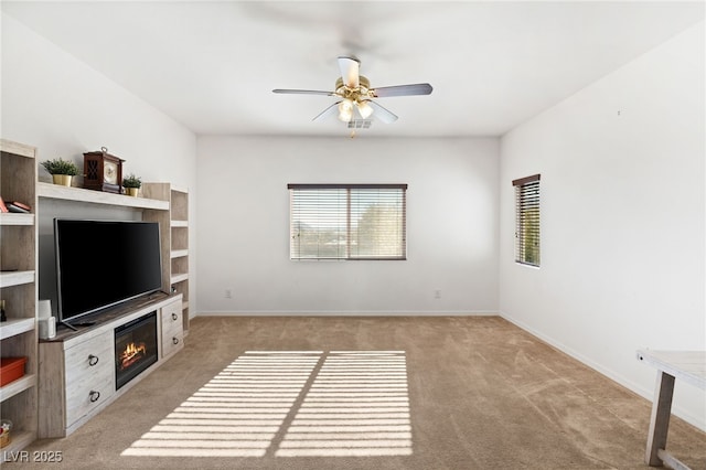 carpeted living room featuring ceiling fan