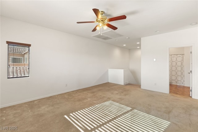 carpeted spare room featuring ceiling fan