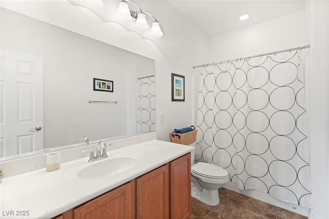 bathroom with a shower with curtain, vanity, and toilet