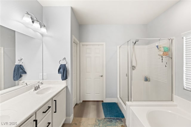 bathroom with vanity, separate shower and tub, and wood-type flooring