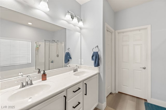 bathroom featuring hardwood / wood-style floors, vanity, and plus walk in shower