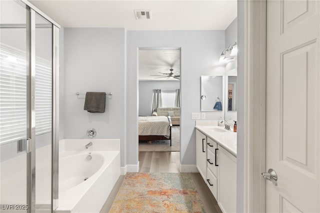 bathroom with vanity, ceiling fan, and a bathing tub