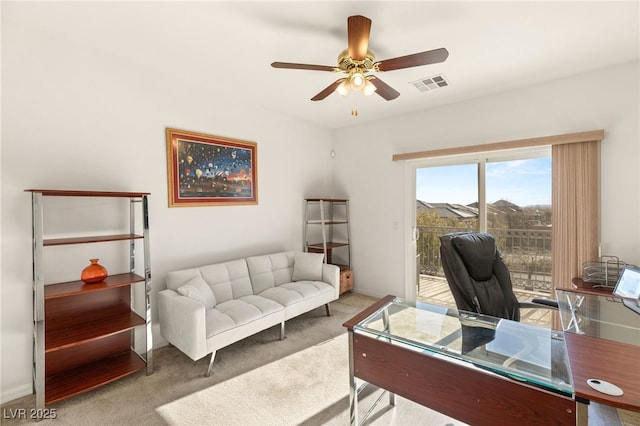 office space featuring ceiling fan and light colored carpet