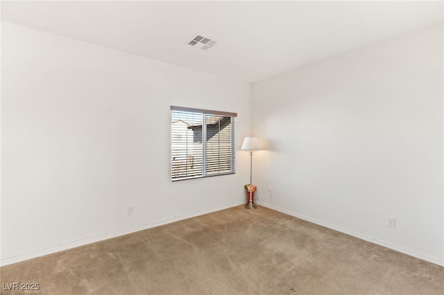 spare room featuring light colored carpet