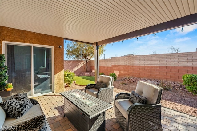 view of patio featuring an outdoor living space with a fire pit