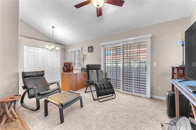 sitting room with ceiling fan with notable chandelier, vaulted ceiling, and light colored carpet