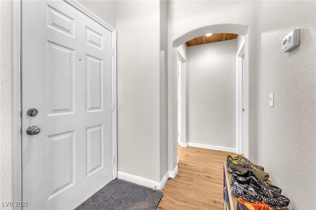 hallway with light hardwood / wood-style floors