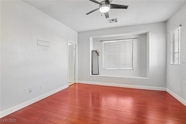 empty room with ceiling fan and hardwood / wood-style flooring