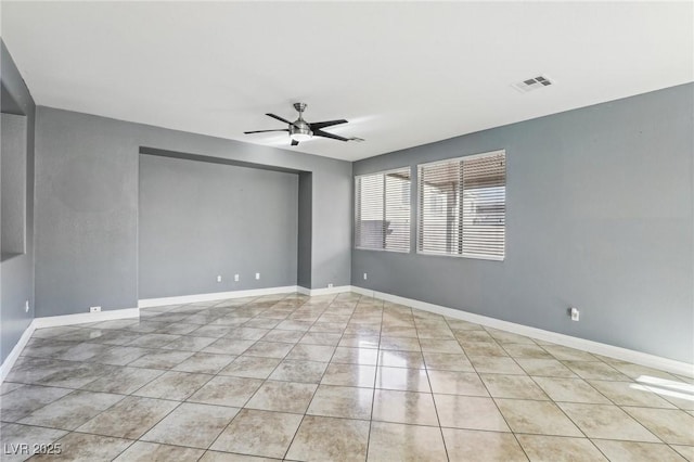 empty room featuring light tile patterned floors and ceiling fan