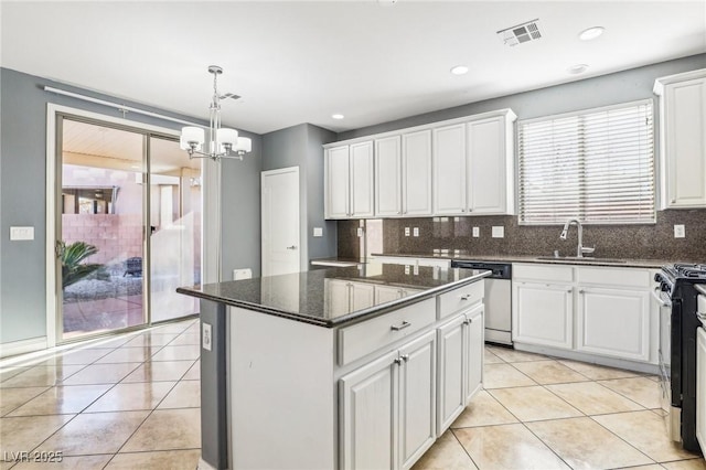 kitchen featuring white cabinets, a kitchen island, and sink