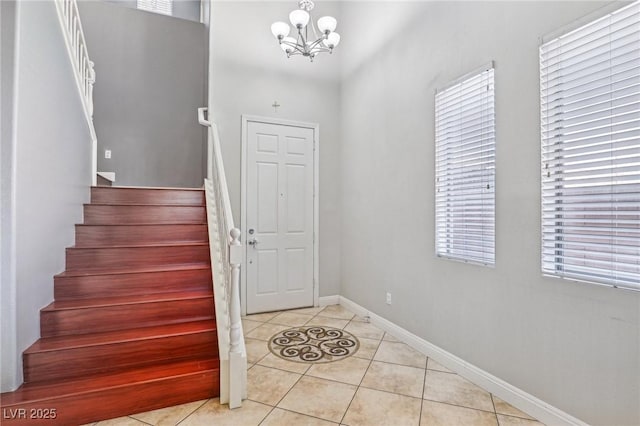 entrance foyer with plenty of natural light, light tile patterned floors, and a chandelier