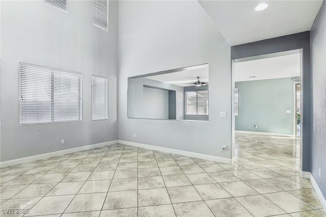 empty room featuring light tile patterned floors and ceiling fan