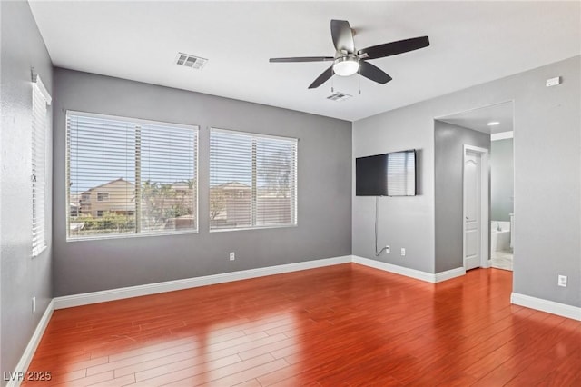 empty room with ceiling fan and wood-type flooring