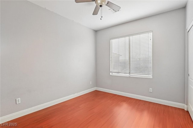 empty room with ceiling fan and hardwood / wood-style floors