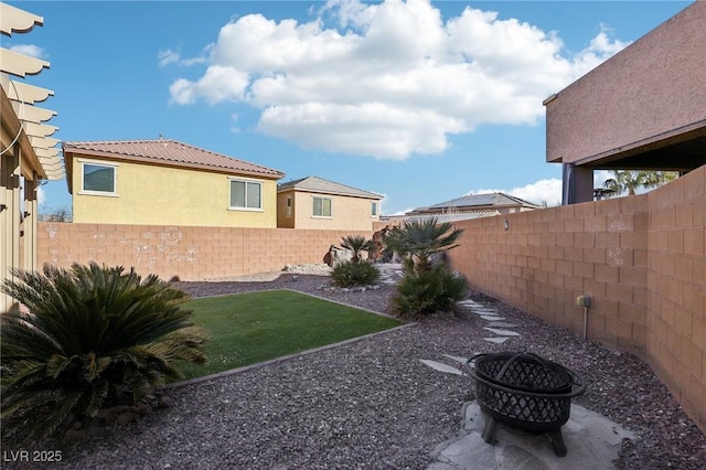 view of yard with an outdoor fire pit