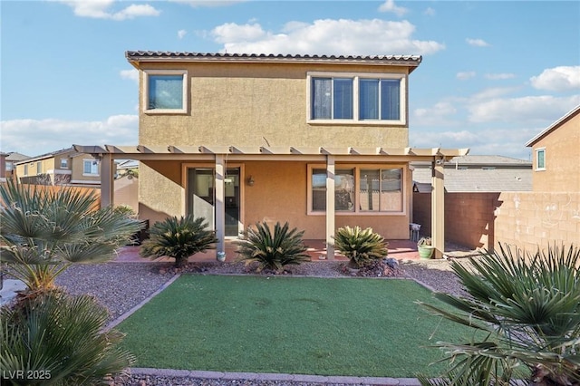 rear view of house featuring a lawn