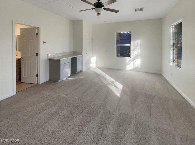 carpeted spare room with ceiling fan