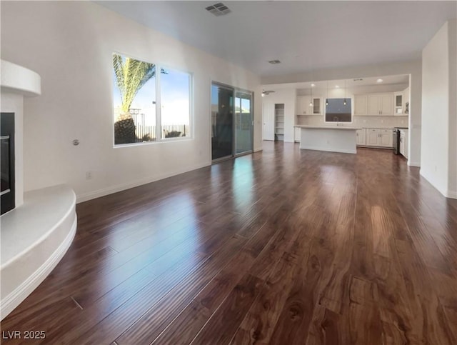 unfurnished living room featuring dark hardwood / wood-style floors