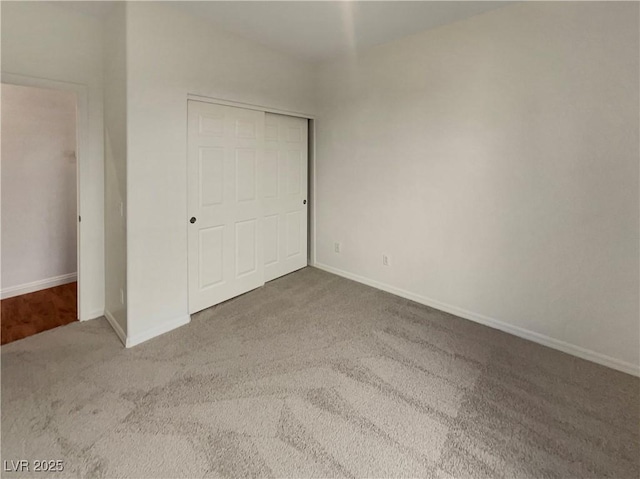 unfurnished bedroom with a closet and carpet floors