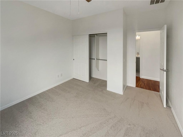 unfurnished bedroom featuring ceiling fan, a closet, and carpet