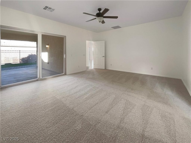 empty room featuring carpet flooring and ceiling fan