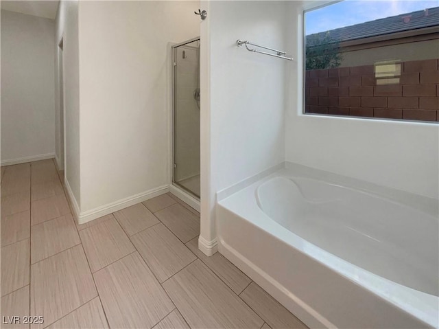 bathroom featuring independent shower and bath