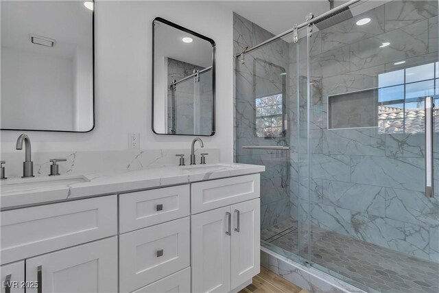 bathroom featuring wood-type flooring, vanity, and walk in shower