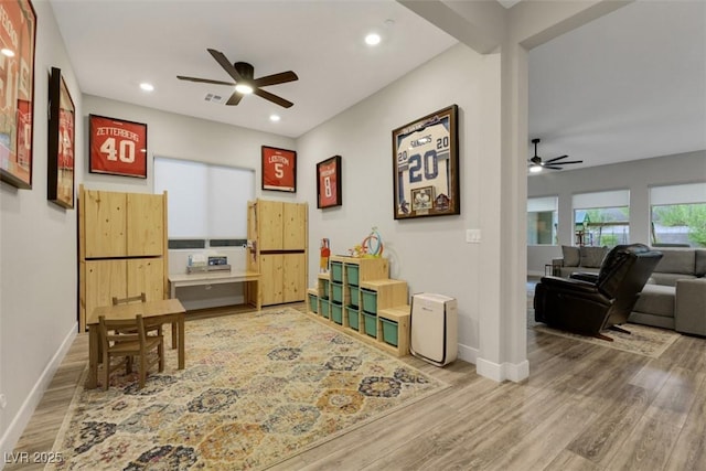 living area featuring ceiling fan and hardwood / wood-style floors